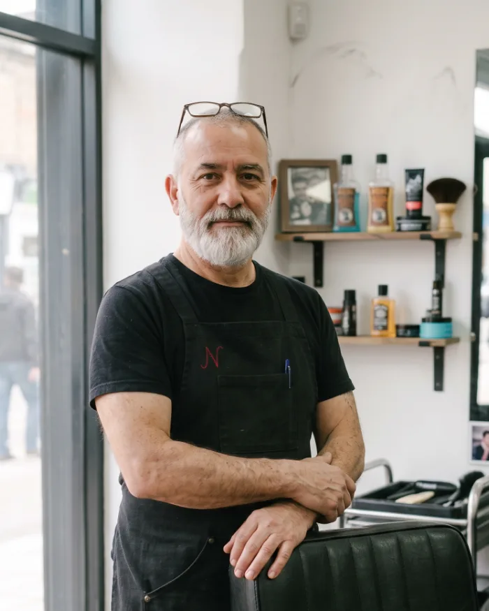 Luis, the shop owner, beside his chair